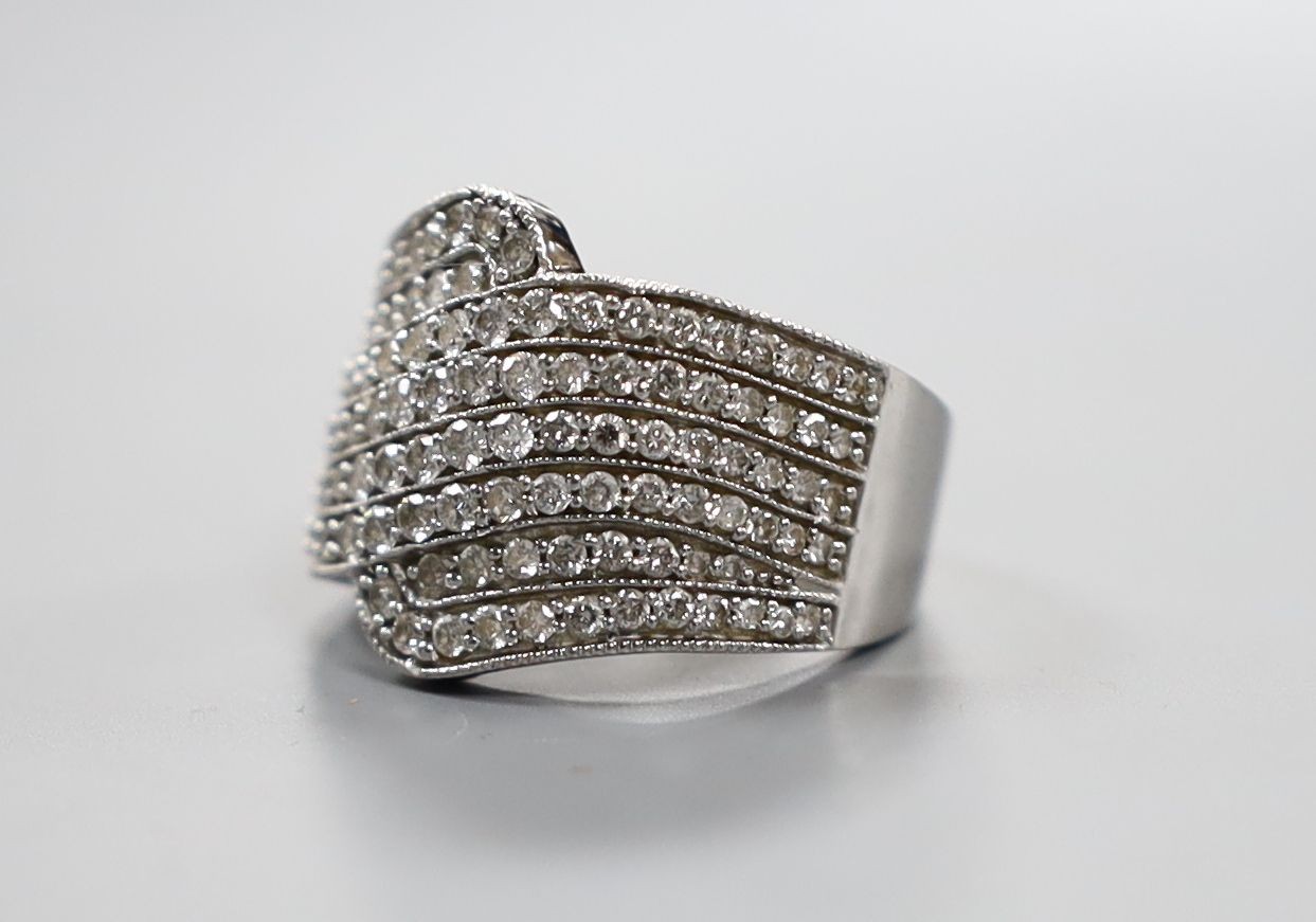 A modern 18ct white gold and pave set diamond dress ring, size O, gross 8.4 grams